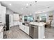 Modern eat-in kitchen featuring stainless steel appliances, large island, and dining table at 640 Bayern Ln, Debary, FL 32713