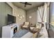 Cozy lanai with comfortable seating, ceiling fan, television, and view of the outdoors at 640 Bayern Ln, Debary, FL 32713
