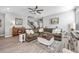Spacious living room with hardwood floors, fan, a comfy couch, and an ornate rug at 640 Bayern Ln, Debary, FL 32713