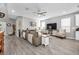 Spacious living room with hardwood floors, a comfy couch, tv and fireplace at 640 Bayern Ln, Debary, FL 32713