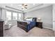Spacious main bedroom features a trey ceiling, large windows, and neutral carpet at 640 Bayern Ln, Debary, FL 32713