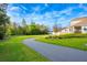 Paved walking path in the community with well-maintained lawns and natural scenery at 640 Bayern Ln, Debary, FL 32713