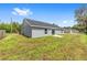 Exterior view of home from backyard with slider to patio at 654 Ne 130Th Ct, Silver Springs, FL 34488
