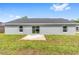 Exterior view of backyard with concrete patio and slider at 654 Ne 130Th Ct, Silver Springs, FL 34488