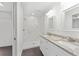 Bathroom featuring double sinks with granite countertops and a glass-enclosed shower at 654 Ne 130Th Ct, Silver Springs, FL 34488