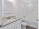 Bathroom featuring single sink with granite countertops, shower and toilet at 654 Ne 130Th Ct, Silver Springs, FL 34488
