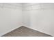 Walk-in closet features shelving and hardwood floors at 654 Ne 130Th Ct, Silver Springs, FL 34488