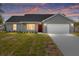 Charming single-story home featuring a two-car garage, neat landscaping, and a freshly painted exterior at 654 Ne 130Th Ct, Silver Springs, FL 34488