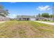 A single-story home with a freshly painted exterior, bright red front door, and newly installed grass at 654 Ne 130Th Ct, Silver Springs, FL 34488
