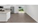 Modern kitchen with stainless appliances, white cabinets, and a sliding glass door to the backyard at 654 Ne 130Th Ct, Silver Springs, FL 34488