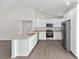 Modern kitchen with white cabinets, stainless steel appliances, and granite countertops at 654 Ne 130Th Ct, Silver Springs, FL 34488
