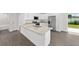 Kitchen featuring granite counters, stainless appliances, and a door to the modern bathroom at 654 Ne 130Th Ct, Silver Springs, FL 34488
