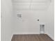 Laundry room featuring shelving, hardwood floors, and hookups at 654 Ne 130Th Ct, Silver Springs, FL 34488