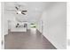Open-concept living space with hardwood floors, a ceiling fan, and a kitchen featuring stainless steel appliances at 654 Ne 130Th Ct, Silver Springs, FL 34488