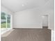 Bright and open living space featuring wood-look flooring, a sliding glass door, and recessed lighting at 654 Ne 130Th Ct, Silver Springs, FL 34488