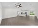 Bright, airy living space featuring hardwood floors and a ceiling fan, seamlessly connecting to the kitchen at 654 Ne 130Th Ct, Silver Springs, FL 34488