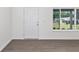 Bright room showcasing hard wood floors, large windows, and crisp white trim at 654 Ne 130Th Ct, Silver Springs, FL 34488