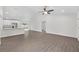 Spacious open-concept living area with hardwood floors, a ceiling fan, and a view of the modern kitchen at 654 Ne 130Th Ct, Silver Springs, FL 34488