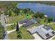 Beautiful aerial view of home on a lake with private pool and pristine landscaping at 6790 Bay Shore Dr, St Cloud, FL 34771
