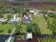 Aerial view of the property featuring the house, swimming pool, private dock, and waterfront at 6790 Bay Shore Dr, St Cloud, FL 34771
