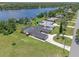 Aerial view of the property with a large lawn, a pool and a private dock on the lake at 6790 Bay Shore Dr, St Cloud, FL 34771