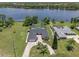 Aerial view of waterfront home featuring lush landscaping, swimming pool, and private dock at 6790 Bay Shore Dr, St Cloud, FL 34771