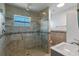 Bathroom featuring tiled glass shower, tiled walls, and modern sink with vanity at 6790 Bay Shore Dr, St Cloud, FL 34771