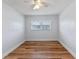Clean bedroom features wood-look floors and natural light from a large window at 6790 Bay Shore Dr, St Cloud, FL 34771