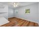 Bright bedroom features wood-look floors, a ceiling fan, and natural light from two windows at 6790 Bay Shore Dr, St Cloud, FL 34771