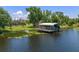 Scenic view of a private boat dock on the water, surrounded by lush greenery at 6790 Bay Shore Dr, St Cloud, FL 34771