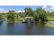 Picturesque waterfront dock with a covered boat lift surrounded by serene water and lush greenery at 6790 Bay Shore Dr, St Cloud, FL 34771