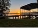 Scenic view of a covered dock at sunrise with the sun glistening on the tranquil water at 6790 Bay Shore Dr, St Cloud, FL 34771