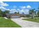 Well-maintained home with a large two-car garage, a spacious driveway, and a lush green lawn at 6790 Bay Shore Dr, St Cloud, FL 34771