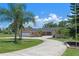 Charming single-story home with mature landscaping and a circular driveway at 6790 Bay Shore Dr, St Cloud, FL 34771