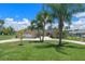 Charming home with a spacious front yard, long driveway, and lush green lawn at 6790 Bay Shore Dr, St Cloud, FL 34771