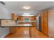 Bright kitchen featuring wood cabinets, stainless steel appliances, and a tile countertop at 6790 Bay Shore Dr, St Cloud, FL 34771