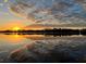 Scenic lake view with a vivid sunset reflecting off of the water and vibrant cloudscape at 6790 Bay Shore Dr, St Cloud, FL 34771