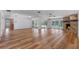 Spacious living room with wood floors, stone fireplace, and views of the pool and lanai at 6790 Bay Shore Dr, St Cloud, FL 34771
