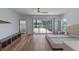 Spacious main bedroom with hardwood floors, ceiling fan, neutral walls and sliding doors to lanai at 6790 Bay Shore Dr, St Cloud, FL 34771