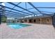 Screened pool features brick pavers and a spa, surrounded by lush landscaping at 6790 Bay Shore Dr, St Cloud, FL 34771