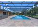 Screened pool features brick pavers and spa, situated in a private outdoor space at 6790 Bay Shore Dr, St Cloud, FL 34771