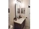 A modern bathroom with a vanity, stylish mirror, contemporary lighting, and minimalist decor at 725 Ashworth Overlook Dr # C, Apopka, FL 32712