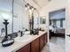 Bathroom features a double sink vanity with decorative accents and an arched mirror, offering a functional design at 725 Ashworth Overlook Dr # C, Apopka, FL 32712