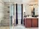Well-lit bathroom featuring a double sink vanity, a modern shower with designer tile, and stylish finishes at 725 Ashworth Overlook Dr # C, Apopka, FL 32712