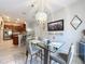 Elegant dining room with a glass-top table, stylish chairs, and contemporary lighting fixtures at 725 Ashworth Overlook Dr # C, Apopka, FL 32712