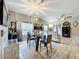 Open-concept dining area with modern light fixture, stylish furniture, and lots of natural light at 725 Ashworth Overlook Dr # C, Apopka, FL 32712
