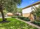 Side view of a two-story home with an adjacent green lawn and sidewalk leading to the entrance at 725 Ashworth Overlook Dr # C, Apopka, FL 32712