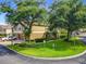 Exterior view of a two-story building with a well-maintained lawn, manicured bushes and a parking area on the left at 725 Ashworth Overlook Dr # C, Apopka, FL 32712