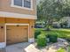 Attached one-car garage with a well-manicured lawn and landscaping at 725 Ashworth Overlook Dr # C, Apopka, FL 32712