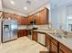 Kitchen with wood cabinets, stainless steel appliances and a double sink at 725 Ashworth Overlook Dr # C, Apopka, FL 32712